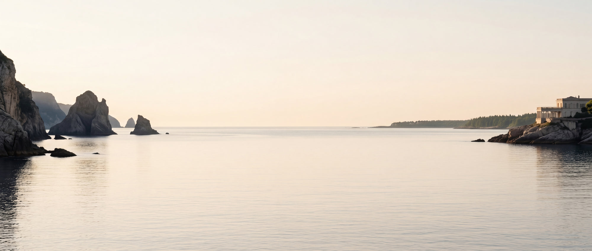 Sweeping coastal landscape at dawn, with a calm sea and soft sky in the center, and dramatic rock formations on the sides.